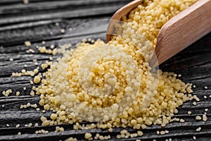 Fresh couscous on a wooden rustic background