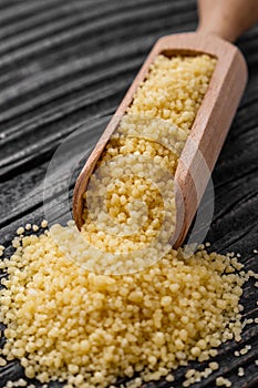 Fresh couscous on a wooden rustic background