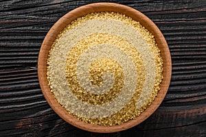 Fresh couscous on a wooden rustic background