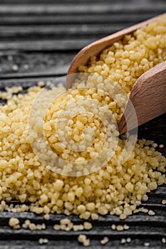 Fresh couscous on a wooden rustic background