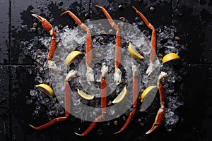 Fresh crab legs on ice and lemon