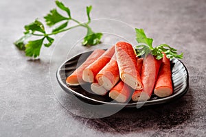 Fresh crab sticks on black plate