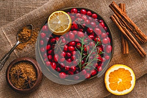 Fresh cranberries, cinnamon, anise, orange, brown sugar, rosemary, and lemon close up