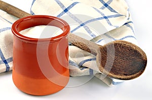 Fresh cream ramekin with a wooden spoon