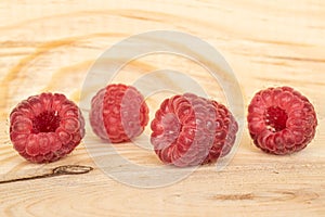 Fresh crimson raspberry on wood