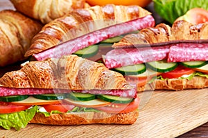 Fresh croissant with salami, chesse and vegetables