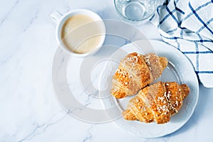 Fresh croissants with berries and cup of coffee