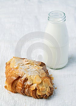 Fresh croissants bread and a cup of coffee on fabric.