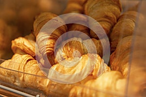 Fresh croissants on the counter. Delicious traditional breakfast pastries. Close-up