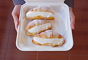 Fresh croissants with cream cheese  in  delivery box