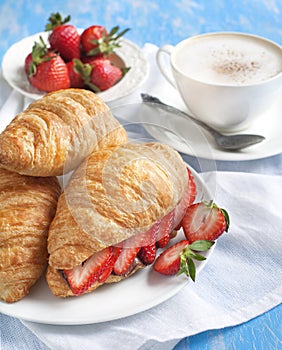 Fresh croissants with strawberry and chocolate nuts cream