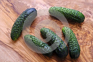 Fresh crunchy cucumbers, walnut board