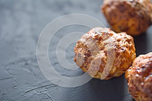 Fresh crunchy muffins on a dark background. Handmade cakes. Closeup view. Copyspace for text