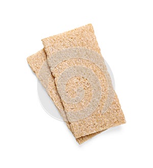 Fresh crunchy rye crispbreads on white background, top view. Space for text