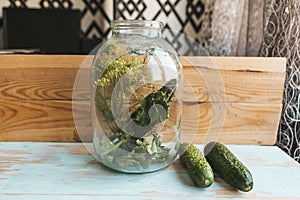 Fresh cucucmbers in glass jar.
