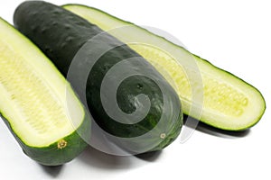 Fresh cucumber and slices isolated on white