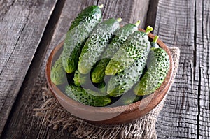 Fresh cucumbers in wooden bowl