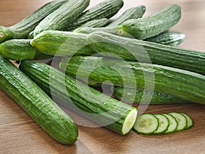 Fresh cucumbers on a wooden decks