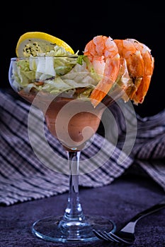 Fresh cuisine Prawn cocktail served in a tropical restaurant in a margarita glass with decoration of prawn on the corner with