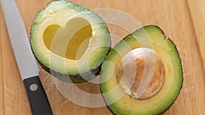 Fresh Cut Avocado With Heart Shaped Pit Area On Cutting Board