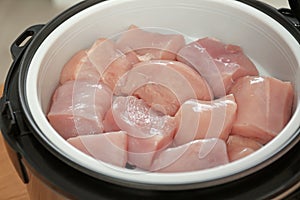 Fresh cut chicken in modern multi cooker