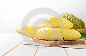 Fresh cut durian monthong on wood block and white wood