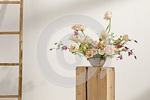 Fresh cut flower arrangement on wooden stump in a vase for decoration for home, for interiors.Flowers delivery concept.