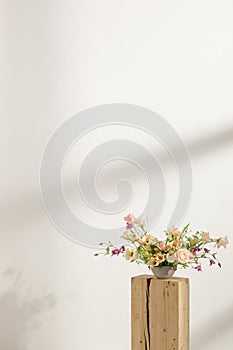 Fresh cut flower arrangement on wooden stump in a vase for decoration for home, for interiors.Flowers delivery concept.