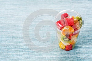 Fresh cut fruit in a plastic cup