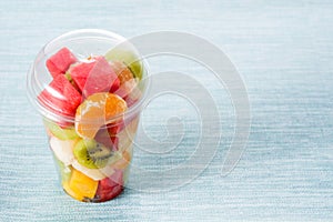 Fresh cut fruit in a plastic cup