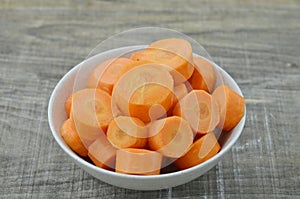 Fresh cut thick carrots on white bowl
