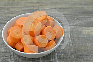 Fresh cut thick carrots on white bowl