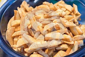 Fresh Cut Up Peeled Apple Wedges In Blue Bowl