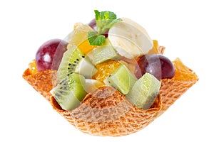 fresh cuted fruits in waffle cone bowl is isolated on white background, concept of healthy dessert for children