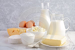 Fresh dairy products. Milk, cheese, brie, Camembert, butter, yogurt, cottage cheese and eggs on wooden table.