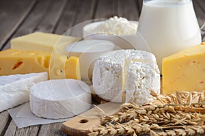 Fresh dairy products. Milk, cheese, brie, Camembert, butter, yogurt, cottage cheese and eggs on wooden table.