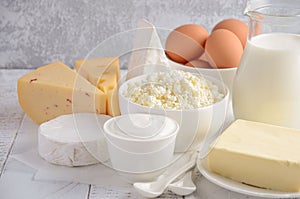 Fresh dairy products. Milk, cheese, brie, Camembert, butter, yogurt, cottage cheese and eggs on wooden table.