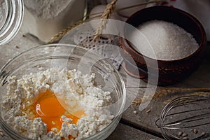 Fresh dairy products. Milk, cottage cheese, sour cream, fresh eggs and wheat on rustic wooden background.