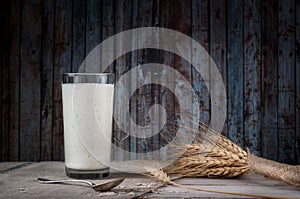 Fresh dairy products and wheat on rustic wooden background. Organic farming dairy concept