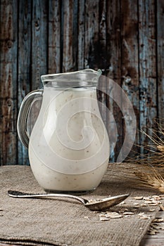 Fresh dairy products and wheat on rustic wooden background. Organic farming dairy concept