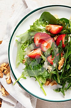 Fresh dandelion salad on light background. Edible plant and nectariferous