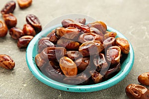 Fresh dates on plate on grey background. Close up