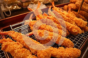 Fresh deepfried japanese tempura shrimps on the street of Osaka