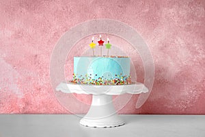 Fresh delicious birthday cake with candles on stand