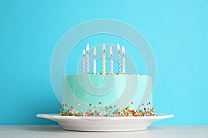 Fresh delicious birthday cake with candles on table