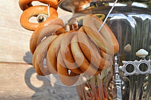 Fresh delicious bread rings bagels, sushki or baranki on old russian samovar