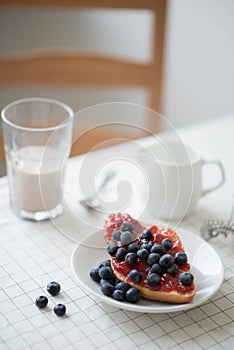 Fresh delicious breakfast with Coffee, crispy croissants, jam on white wooden background. Selective focus.