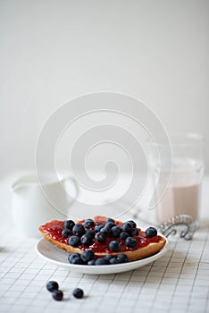 Fresh delicious breakfast with Coffee, crispy croissants, jam on white wooden background. Selective focus.