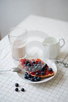 Fresh delicious breakfast with Coffee, crispy croissants, jam on white wooden background. Selective focus.