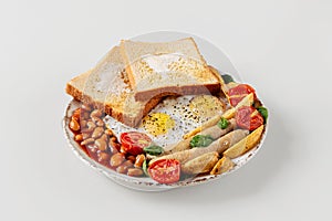 Fresh delicious breakfast on a plate isolated on a white background. tasty fried eggs, viennese sausages, cherry tomatoes and